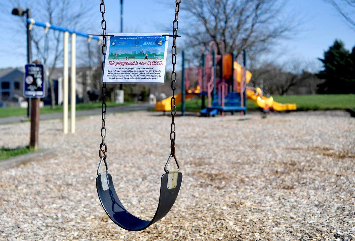 A sign that the playground is closed hangs on one of the swings at Marjorie Mae Park on Monday, April 6, 2020.