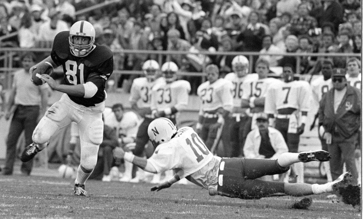 Penn State’s Mike McCloskey (81) eludes the diving-tackle attempt by Nebraska safety Bret Clark during the Sept. 25, 1982, game.