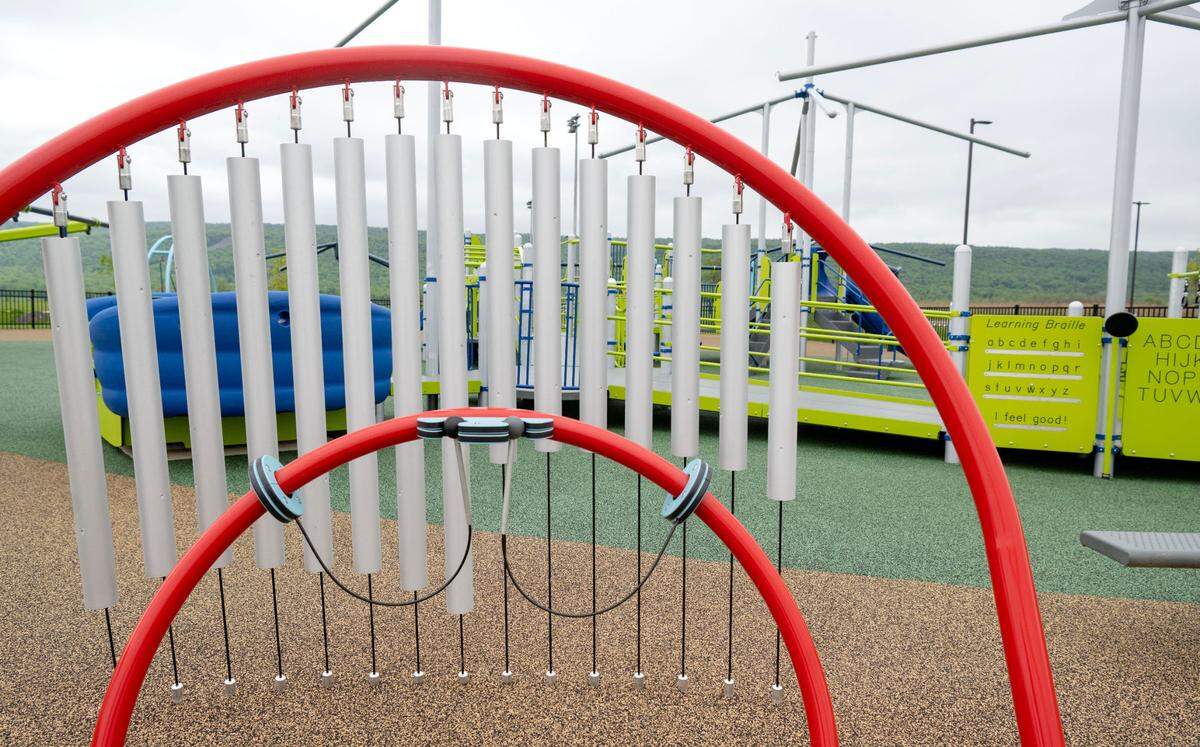 Chimes and other educational features around the all-abilities playground at Whitehall Road Regional Park.