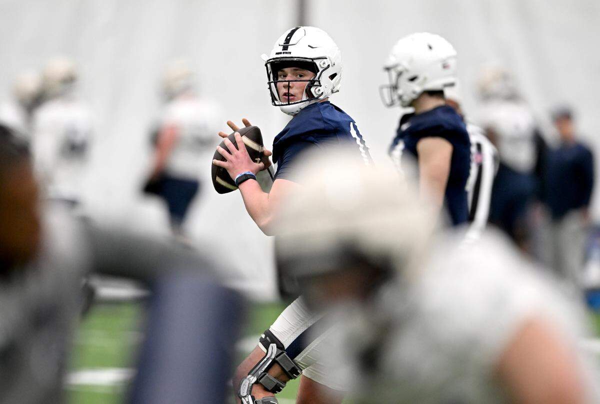 Penn State quarterback Drew Allar watches the receiver run before making a pass during spring practice on Tuesday, March 14, 2023.
