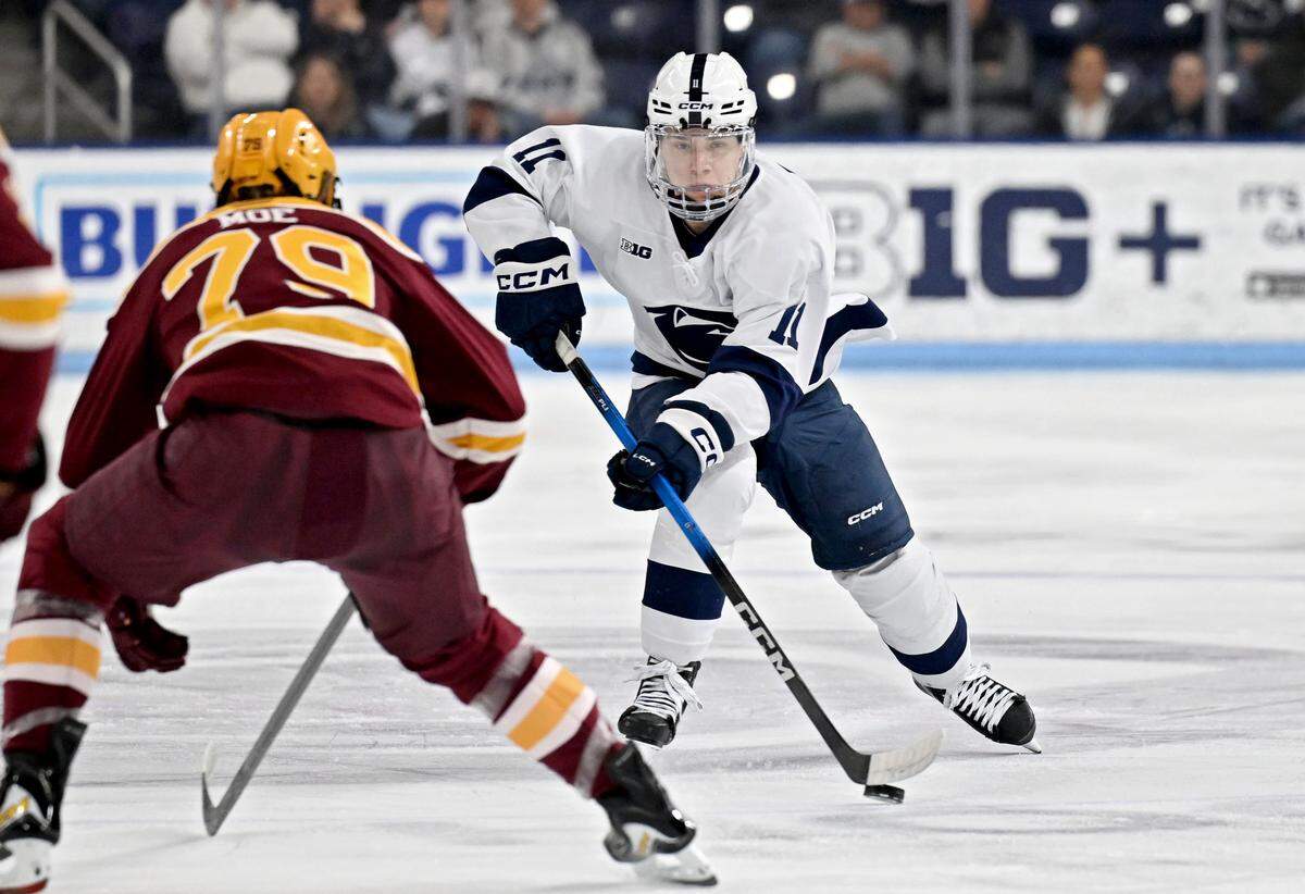 Penn State's Luke Misa skates down the ice with the puck around Minnesota defenders during the game on Wednesday, March 11, 2026 at Pegula Ice Arena. 