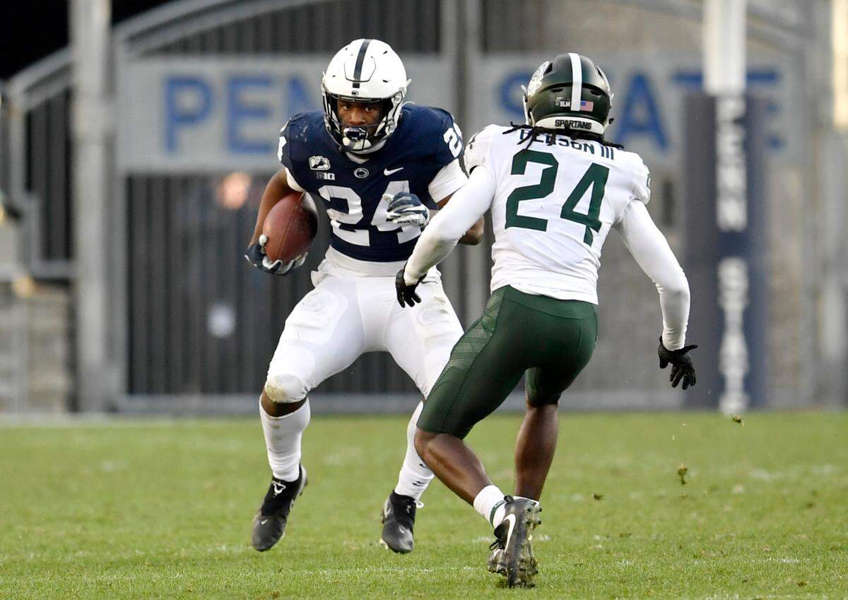 Penn State running back Keyvone Lee cuts around Michigan State safety Tre Person III during the game on Saturday, Dec. 12, 2020 at Beaver Stadium.