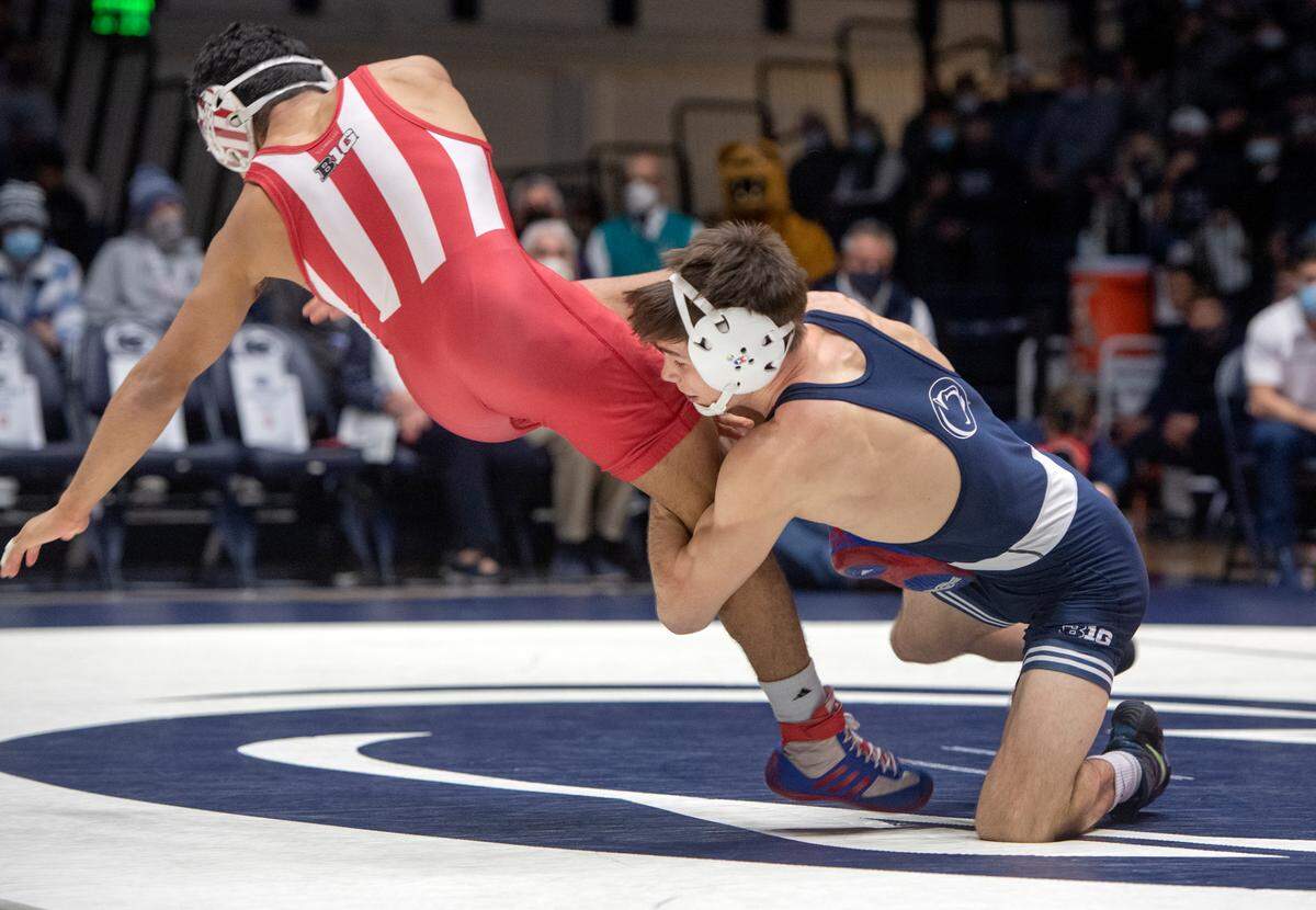 Penn State’s Drew Hildebrandt trips up Indiana’s Jacob Moran in the 125 lb bout during the match on Sunday, Jan. 9, 2022.