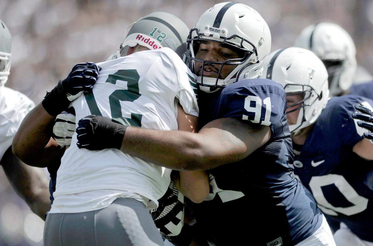 Penn State’s DaQuan Jones stops Eastern Michigan’s quarterback Tyler Benz as he runs with the ball during the Saturday, September 7, 2013 game.