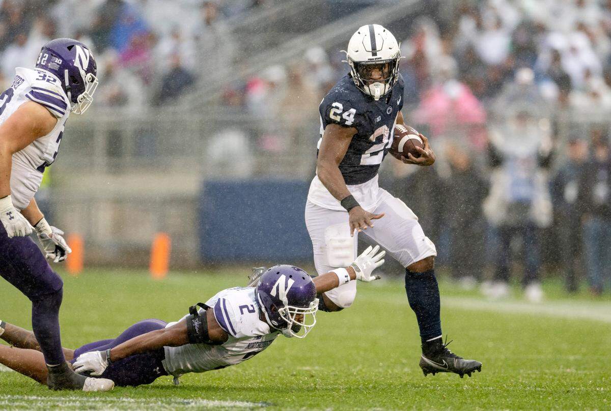 Northwestern’s Cameron Mitchell can’t stop Penn State running back Keyvone Lee as he runs with the ball during the second quarter of the game on Saturday, Oct. 1, 2022.