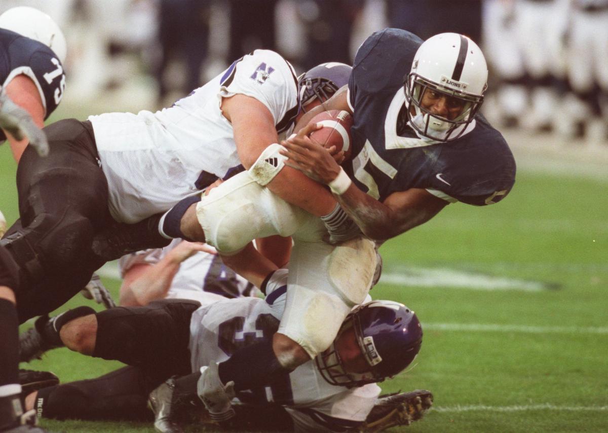 Penn State running back Larry Johnson is brought down by Northwestern defenders during Penn State’s 49-0 win. Johnson rushed for 257 yards, setting the Penn State single-game record previously held by Curt Warner.
