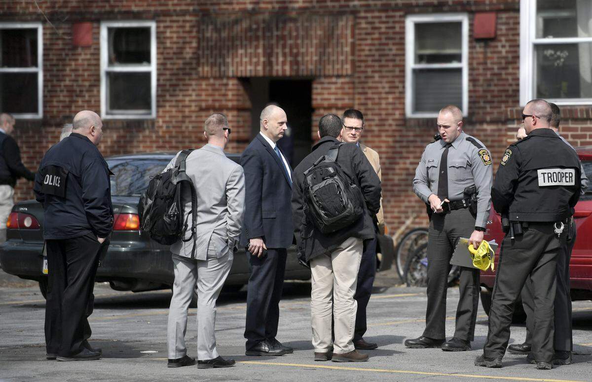 State College Police officers, Pennsylvania State Police officers, and detectives talk outside of Osaze Osagie’s apartment in March 20 after Osagie was fatally shot by a police officer.