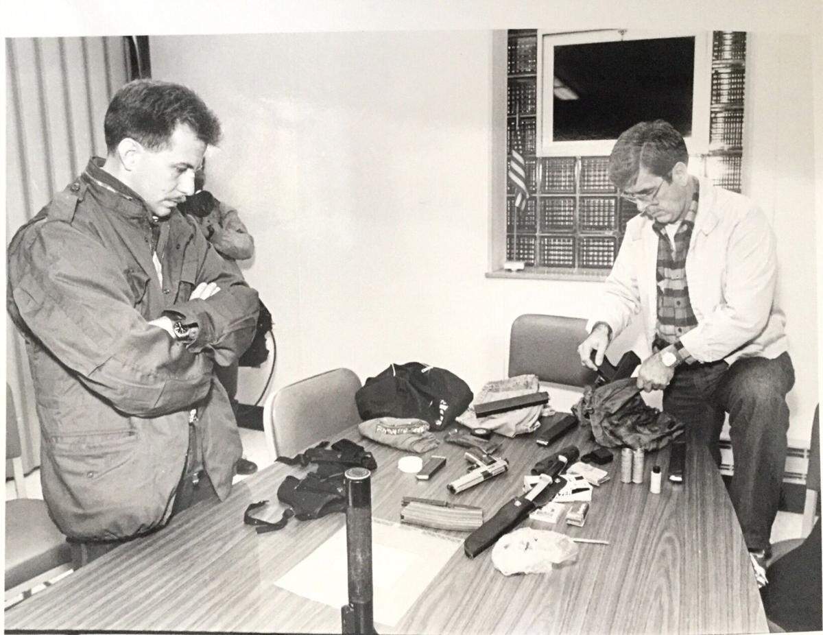 Vincent Pankoke Jr., left, is shown with Richland Police Department Captain Art Watts during an investigation into a bank robbery in a photograph taken at the Conemaugh Township, Somerset County, Police Department.