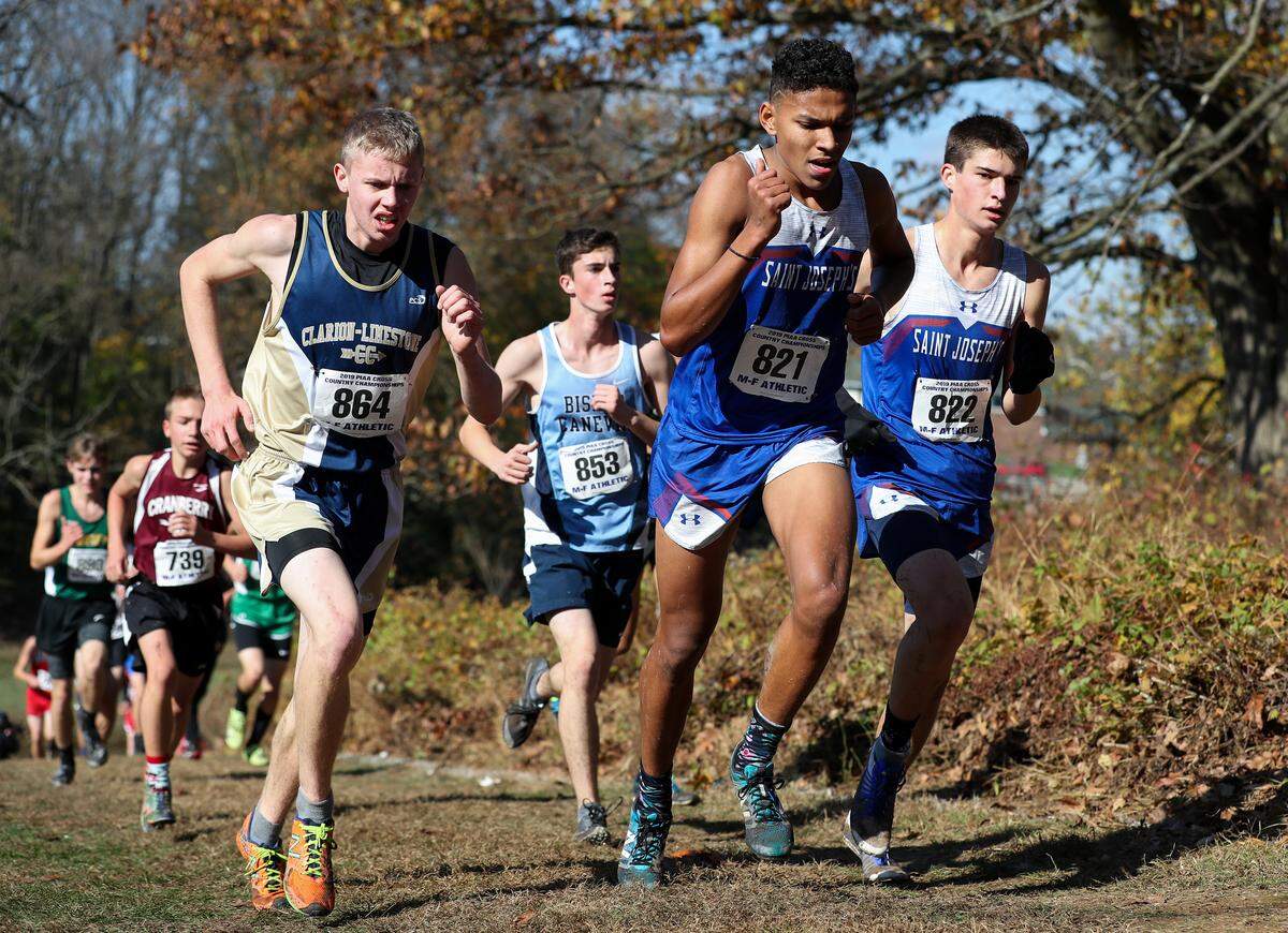St. Joseph Catholic Academy’s Jonah Clark (821) and Aiden Cross (822) compete in the PIAA Class 2A boys cross country championships on Saturday at Parkview Cross Country Course in Hershey.