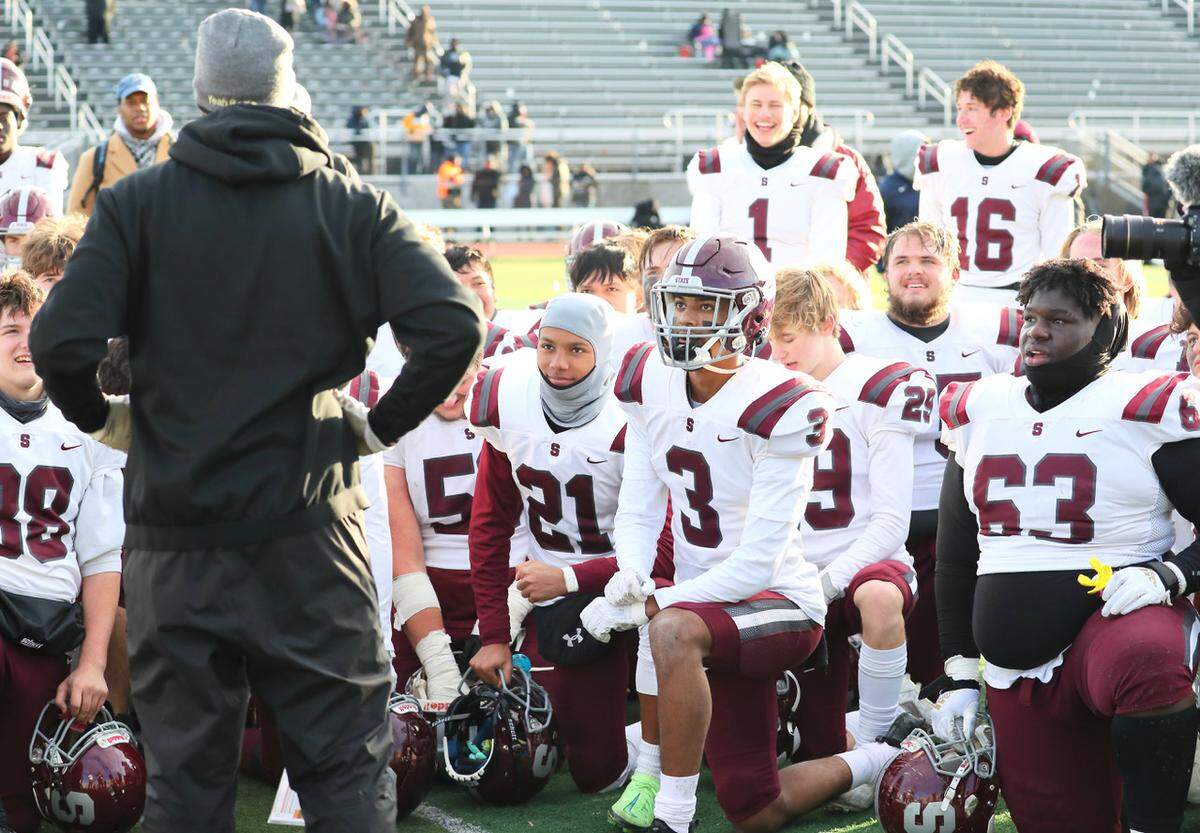 State College coach Matt Lintal talks to his team after beating Harrisburg, 16-13, on Saturday, Nov. 27, 2021, at Severance Field in the PIAA quarterfinals.
