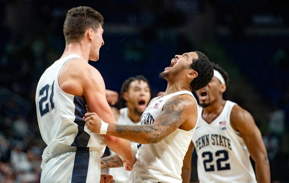 Penn State’s John Harrar, Sam Sessoms and teammates celebrate a basket and a foul with limited time left in the game against Michigan State on Tuesday, Feb. 15, 2022. Penn State won, 62-58.