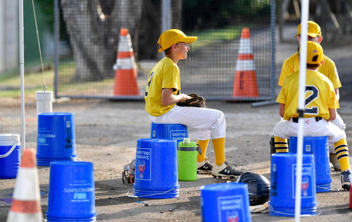 Players on the Knights Bellefonte Little League team chat from their make shift socially distanced dug out during the game on Wednesday, July 8, 2020 at Webster Field.
