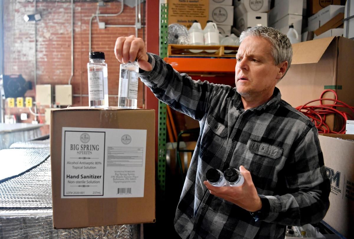 Co-owner and production manager of Big Spring Spirits Kevin Lloyd shows some bottles of hand sanitizer they have made to help the community.