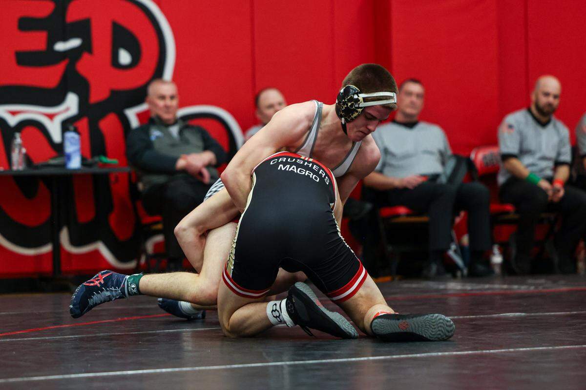 Bellefonte’s Ezra Swisher attempts to fight off a shot attempt from Bishop McCort’s Devon Magro in their 152-pound finals match of the Laurel Highlands Athletic Conference championships on Saturday at Central Cambria High School in Ebensburg. Magro defeated Swisher, 19-4, in 1:41.