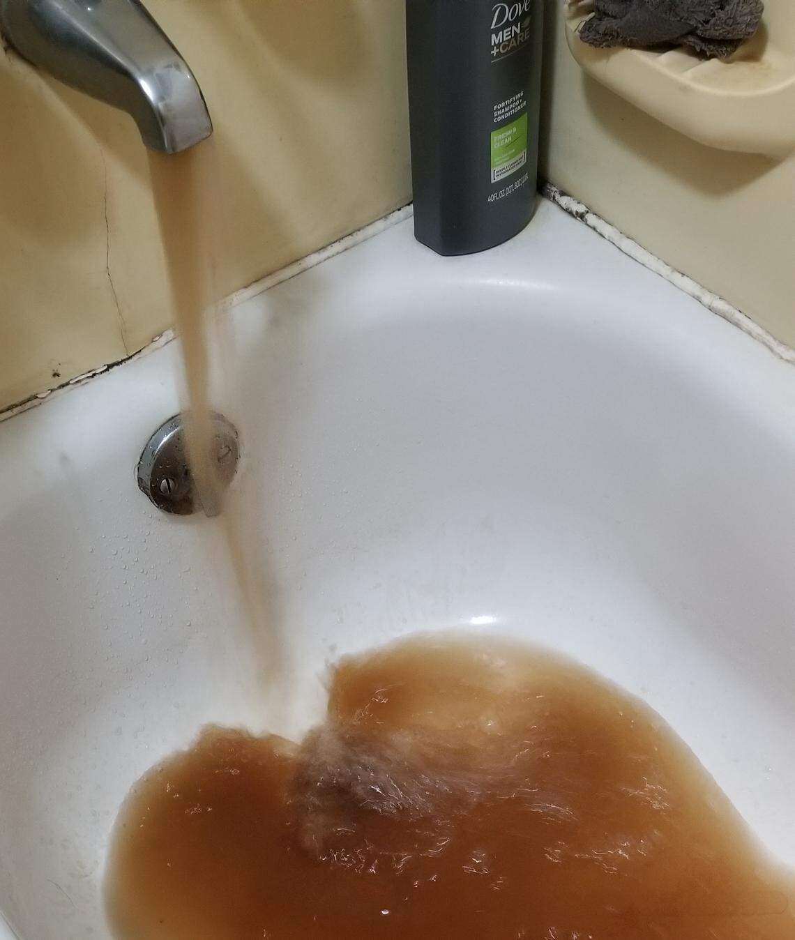 Brown water flowing out of a Mountaintop resident's bathtub faucet, following work done by the water authority to fix leaks and install pressure reducing valves.