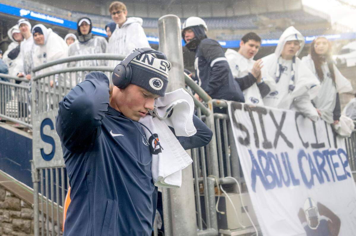 Penn State quarterback Drew Allar pulls his hood up as he walks onto the field for warm-ups for the game against UMass on Saturday, Oct. 14, 2023.