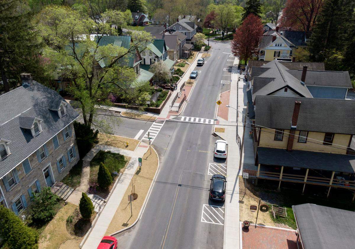 Cars travel along Pike Street in Lemont on Friday, April 21, 2023.