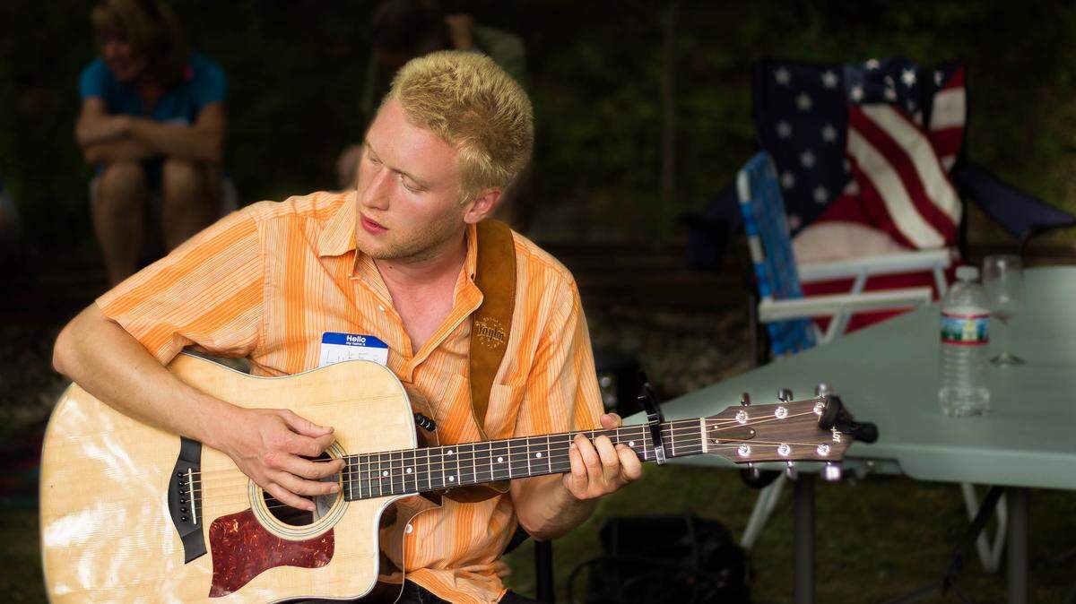Luke Cimbala, founder of The Band Junkies, plays the guitar at a family reunion in Pittsburgh.