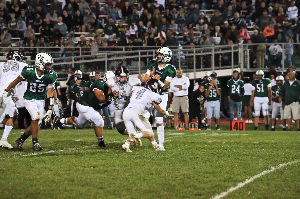 State College’s Kyle Domico makes a hit against Carlisle on Sept. 13.
