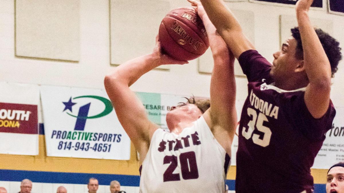 State College’s Brenden Franks draws a foul against Altoona during the District 6 Class 6A championship in Hollidaysburg. State College won 56-53.