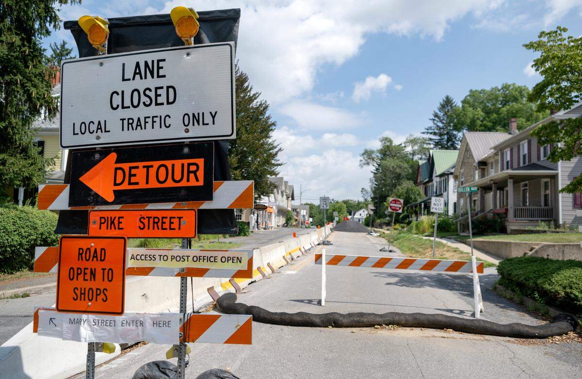 The road closure and detour signs on Pike Street have been updated to people know the shops and post office are accessible.