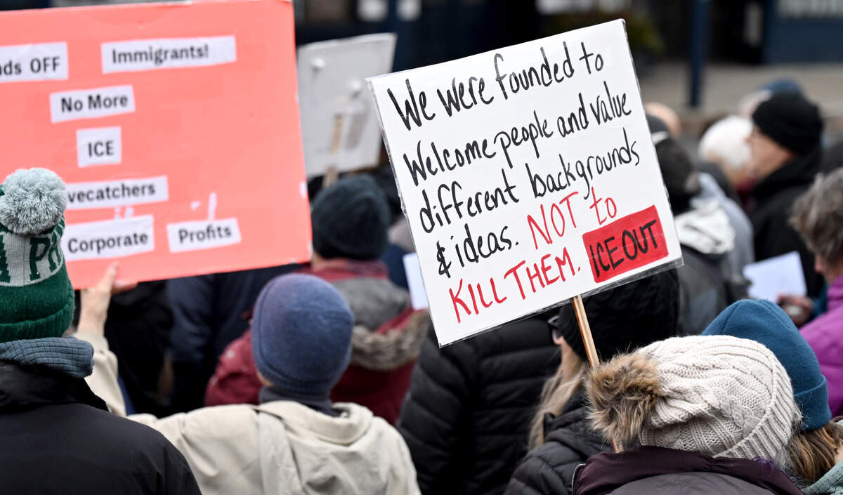 Community members hold signs protesting ICE on Saturday, Jan. 10, 2026.