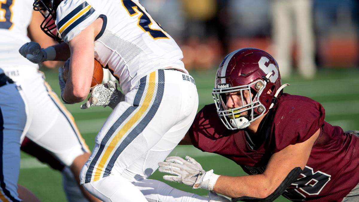 State CollegeÕs Stephen Scourtis dives to stop Mt. LebanonÕs ball carrier during the PIAA class 6A semifinal game on Saturday, Dec. 4, 2021 at Mansion Park. Mt. Lebanon won, 49-28.