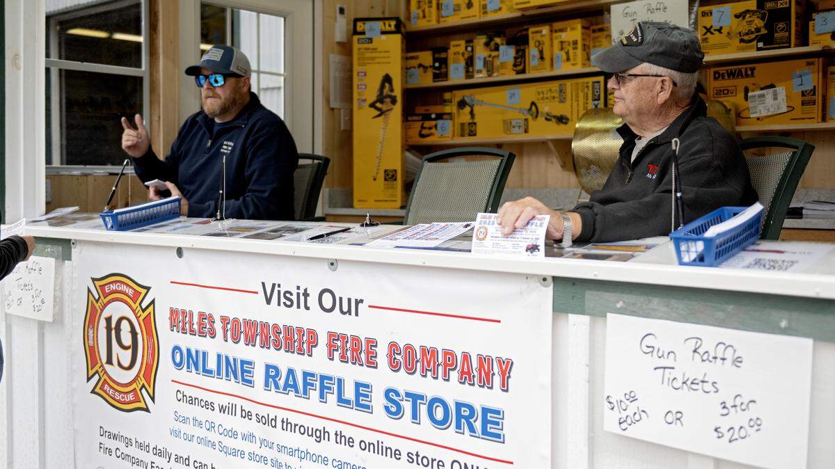 Eric Miller and Chuck Norris sell raffle tickets to support the Miles Township Fire Company at the Centre County Grange Fair on Thursday, Aug. 21, 2025. 