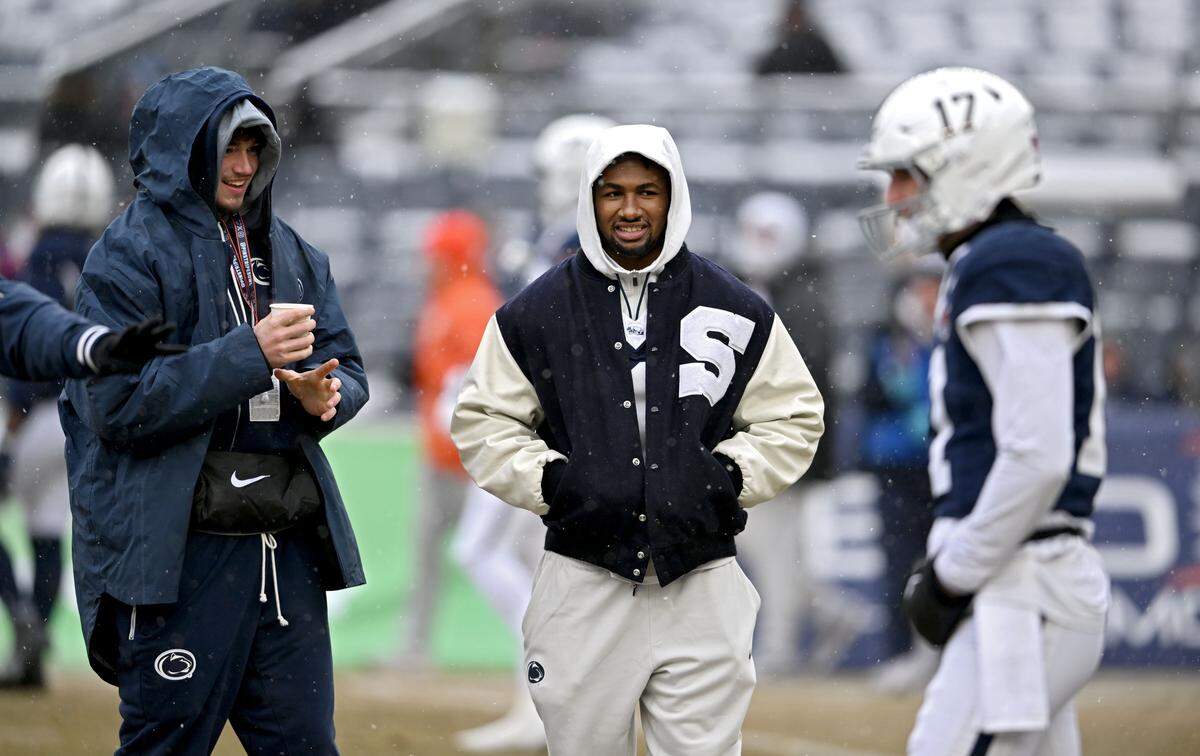 Quarterback Drew Allar, who is recovering from an injury, and running back Nick Singleton, who opted out of the bowl game, watch as quarterback Ethan Grunkemeyer warms up for the Pinstripe Bowl at Yankee Stadium on Saturday, Dec. 27, 2025.  