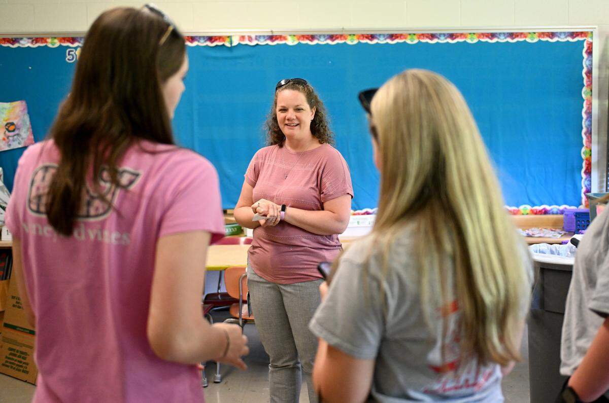 Former students stop by the art classroom to talk to teacher Elizabeth Stover during the Benner Elementary School farewell celebration on Monday, June 1, 2026.