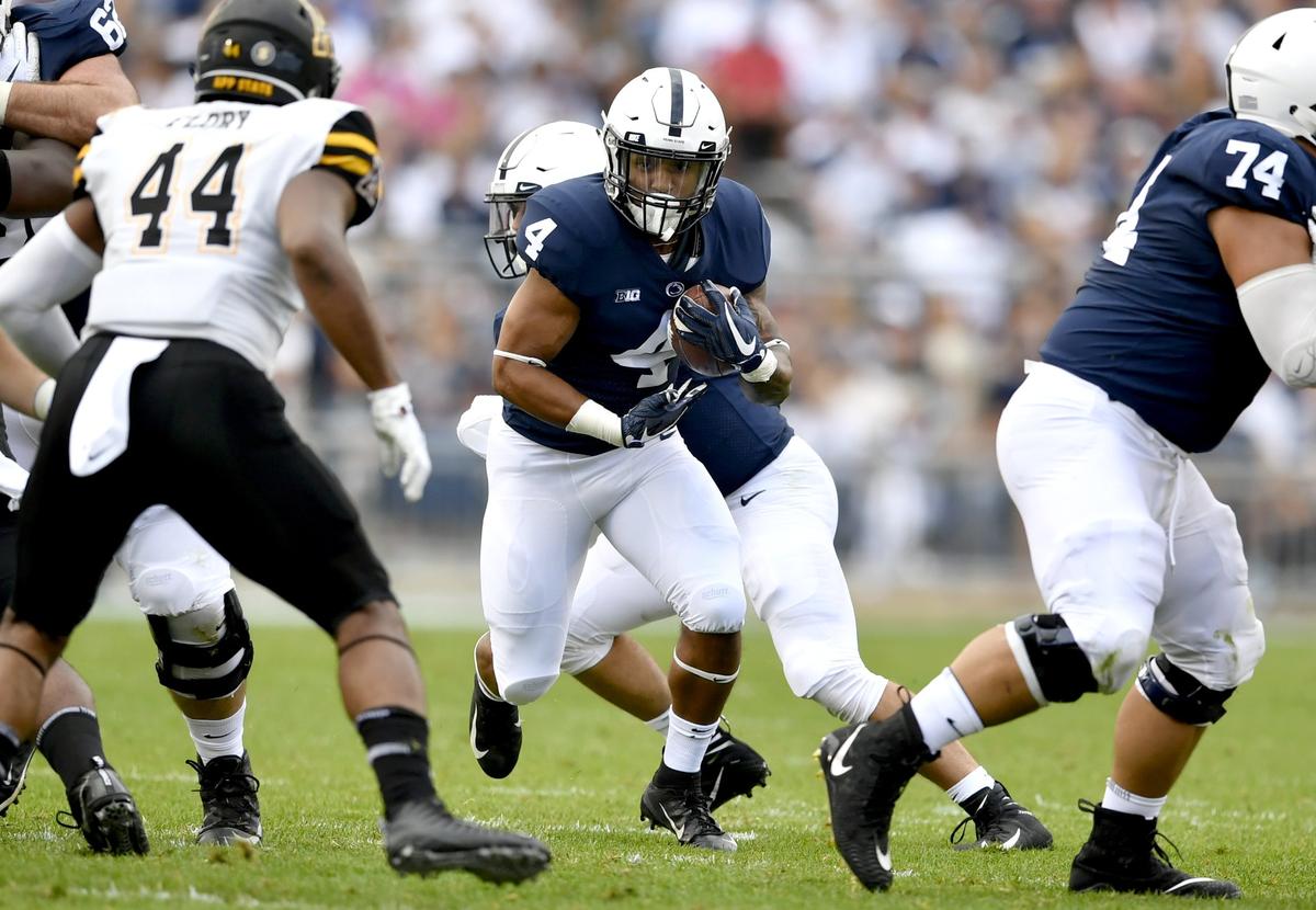 Penn State running back Ricky Slade cuts through Appalachian State defenders during the game Saturday, Sept. 1, 2018  game at Beaver Stadium.