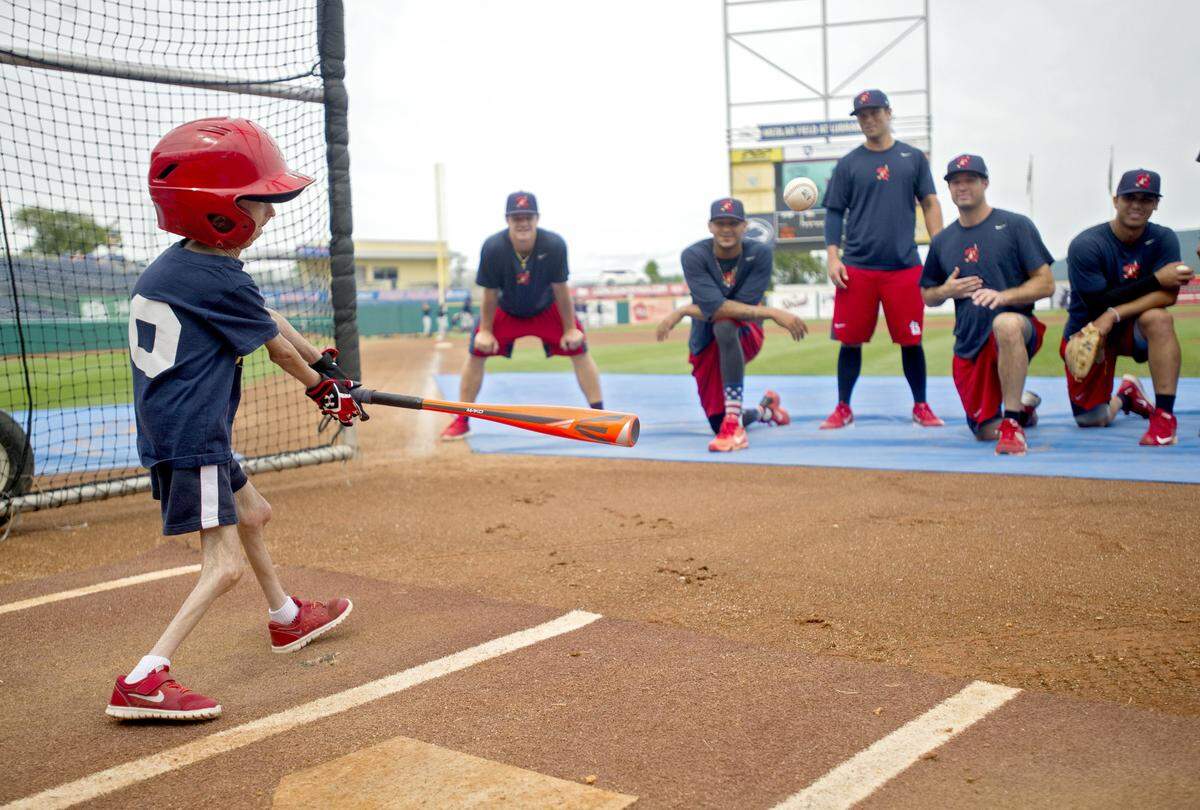 Josiah Viera takes batting practice with the team before the July 3, 2016 game.  The players cheer him on and challenge him to hit the ball to them.  