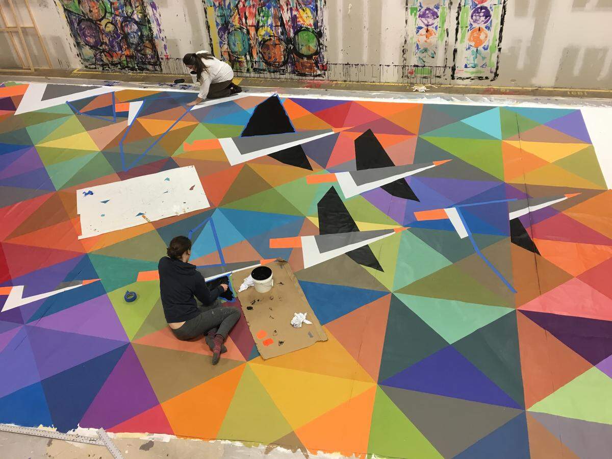 Community members helped with the completion of “Wild Geese,” artist William Snyder III’s new mural in downtown State College.