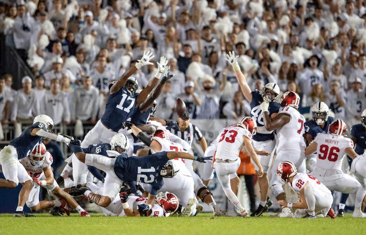 Penn State defenders block an attempted field goal by Indiana’s Charles Campbell.