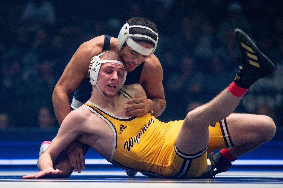 At 149, Shayne Van Ness, back, wrestles Gabe Willochell, front, during the dual meet between Penn State and Wyoming on Sunday, Dec. 15, 2024.
