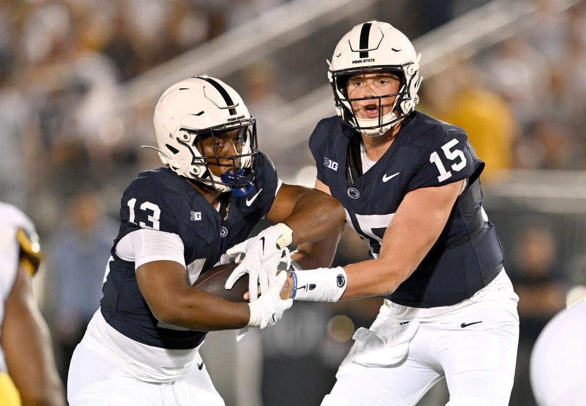 Penn State quarterback Drew Allar hands off to running back Kaytron Allen during the game against West Virginia on Saturday, Sept. 2, 2023.