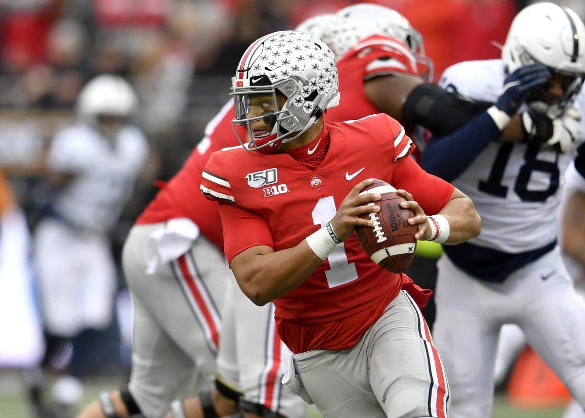 Ohio State quarterback Justin Fields drops back to look for an open teammate to make a pass during the game against Penn State on Saturday, Nov. 23, 2019.