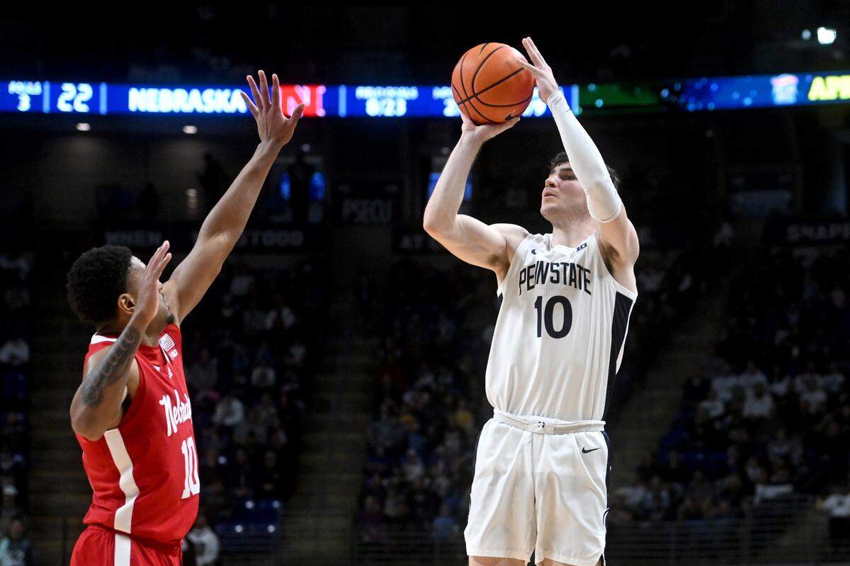 Penn State’s Andrew Funk shoots for three over Nebraska’s Jamarques Lawrence during the game on Saturday, Jan. 21, 2023.