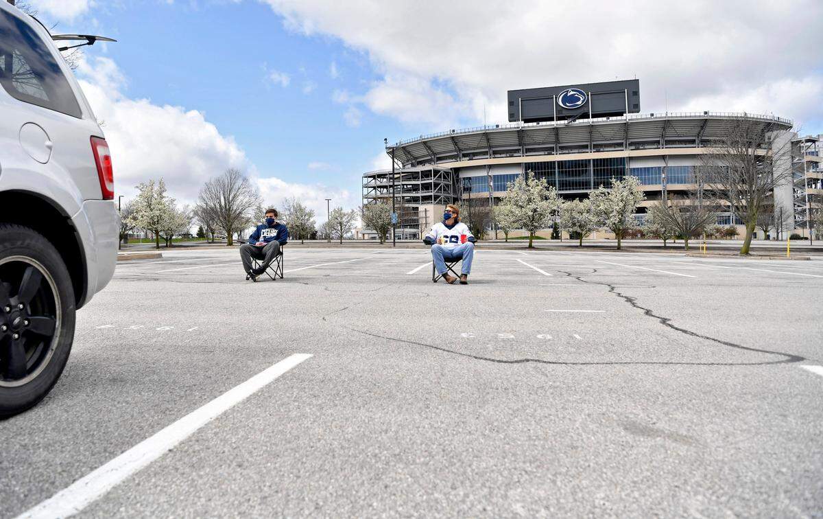 Penn State seniors Tom William and Drew Rose took a few minutes to savor the moment and sit outside of Beaver Stadium for what should have been the Blue-White game on Saturday, April 18, 2020.   