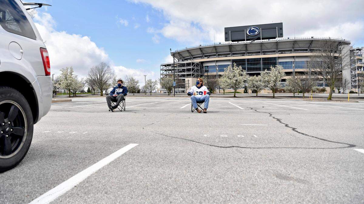 Penn State seniors Tom William and Drew Rose took a few minutes to savor the moment and sit outside of Beaver Stadium for what should have been the Blue-White game on Saturday, April 18, 2020.