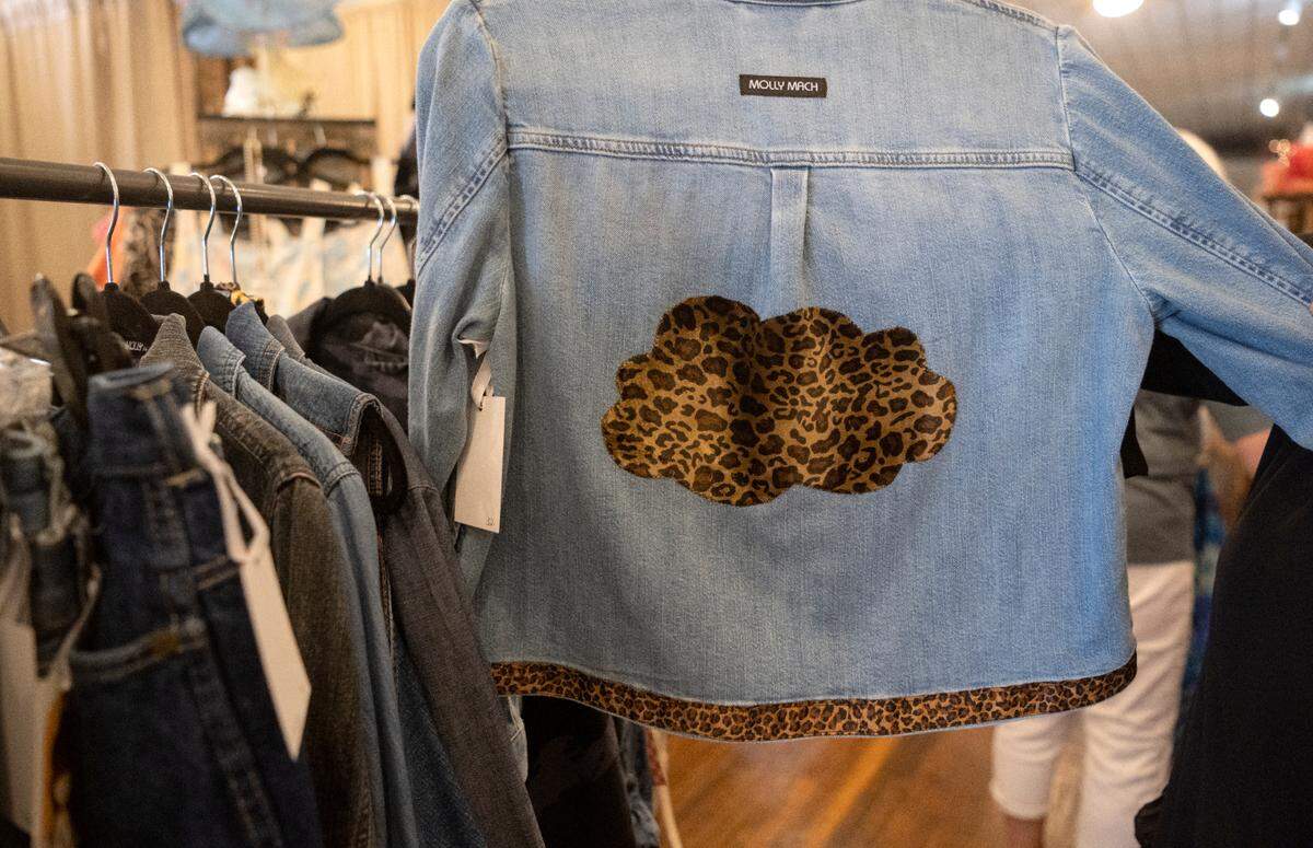 An up-cycled jean jacket featuring a cloud of cheetah print is part of the Molly Mach Collection that will be available at Helen Foxx & Co. on Saturday, July 22, 2023. Molly Marciano loves animal prints and wanted to use it in a cloud design.