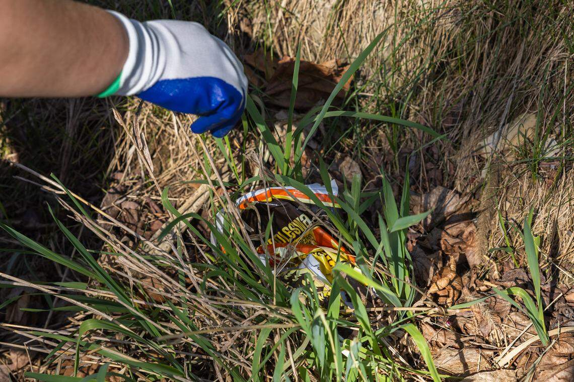 Volunteer Emily Rojik picks up a plastic wrapper in Pine Grove Mills, Pa., on Saturday, April 18, 2026. The ClearWater Conservancy organized volunteers across Centre County to clean up public green spaces.
