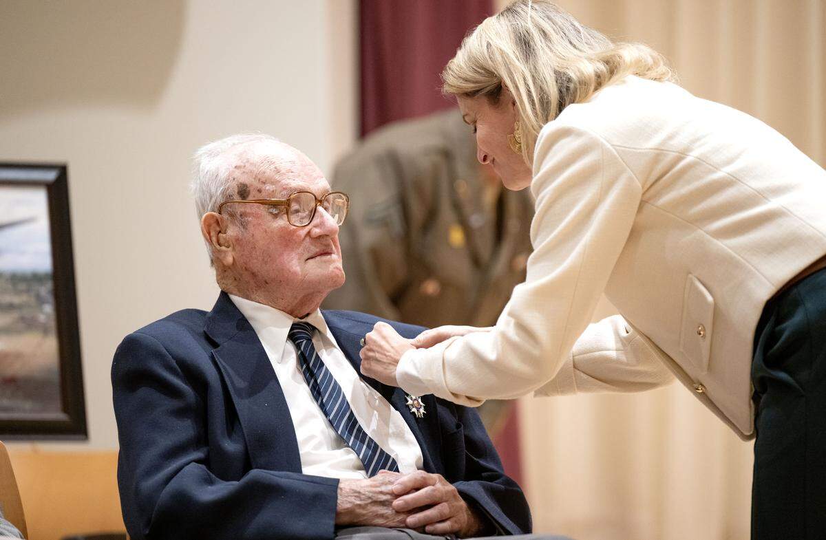 Caroline Monvoisin, a Consul General of France, pins the Legion of Honor medal on 101-year-old World War II veteran John F. Homan during a ceremony at Foxdale Village on Wednesday, Dec. 10, 2025.