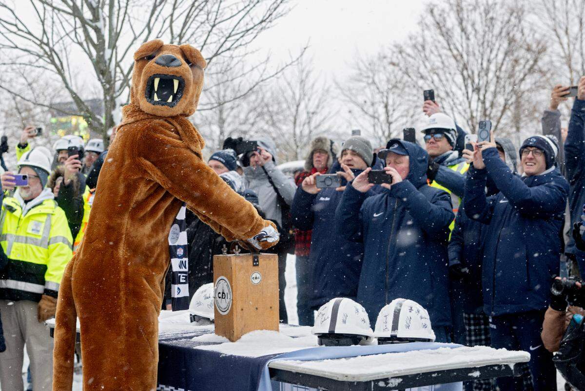 The Penn State Nittany Lion presses a detonator to make the Beaver Stadium press box come down on Saturday, Jan. 4, 2025.