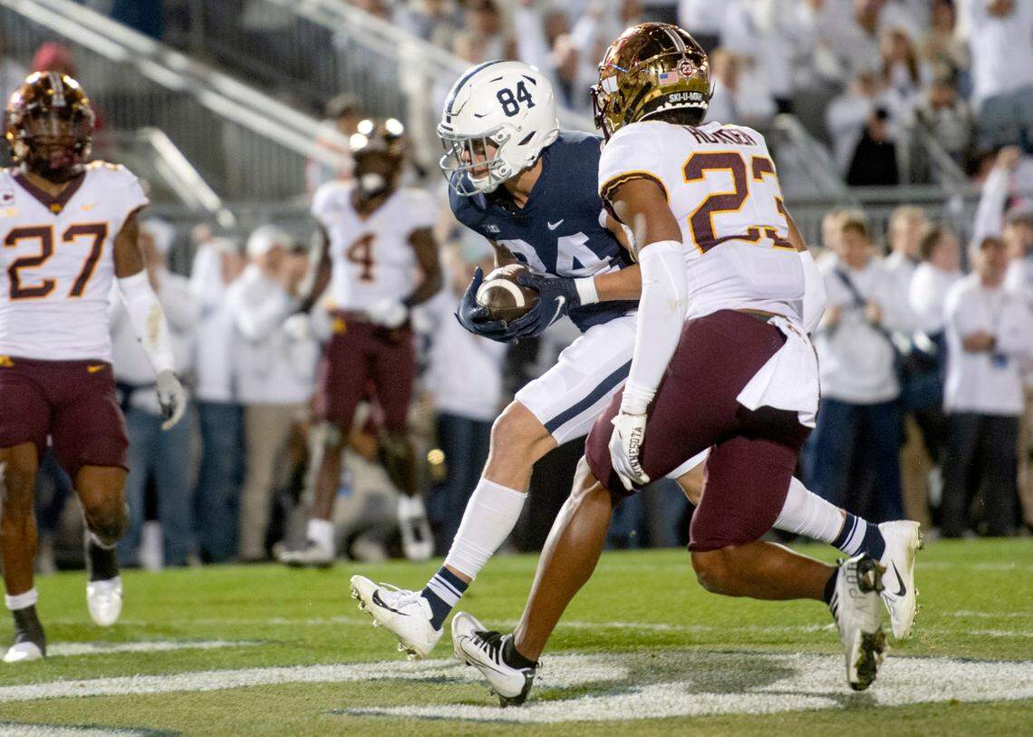 Penn State tight end Theo Johnson runs into the end zone around Minnesota defenders during the game on Saturday.