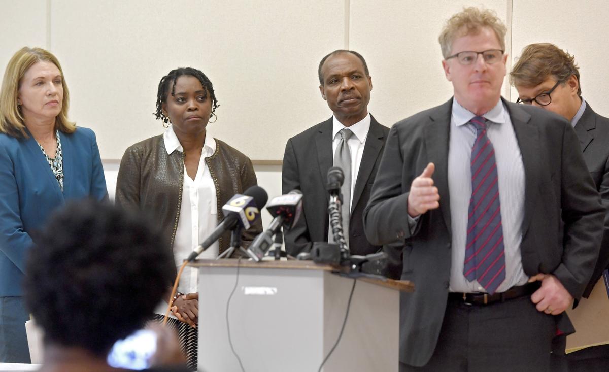 Iyun and Sylvester Osagie listen to one of their attorneys, Andy Shubin, speak during a press conference on Thursday. The family and their legal team will file a lawsuit against the State College Police Department and the officers involved in the fatal shooting of Osagie in March.