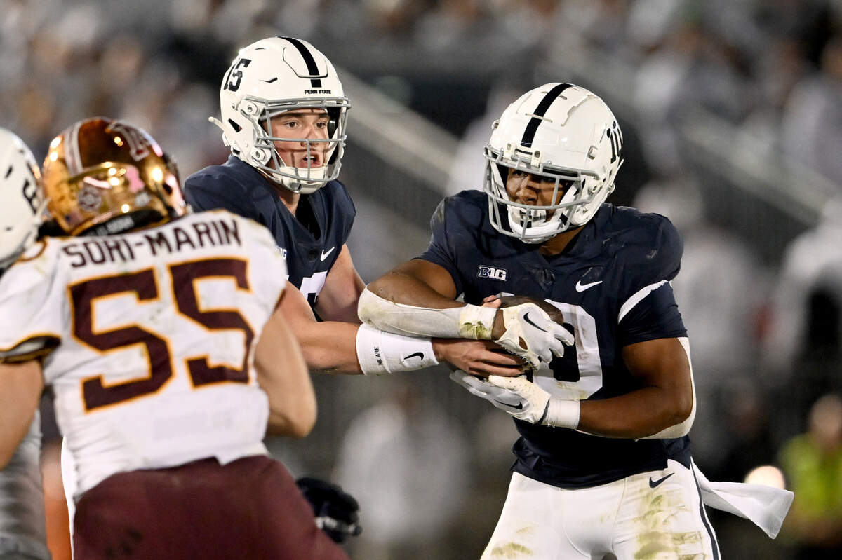 Penn State quarterback Drew Allar hands off to running back Nick Singleton during the game against Minnesota on Saturday, Oct. 22, 2022.