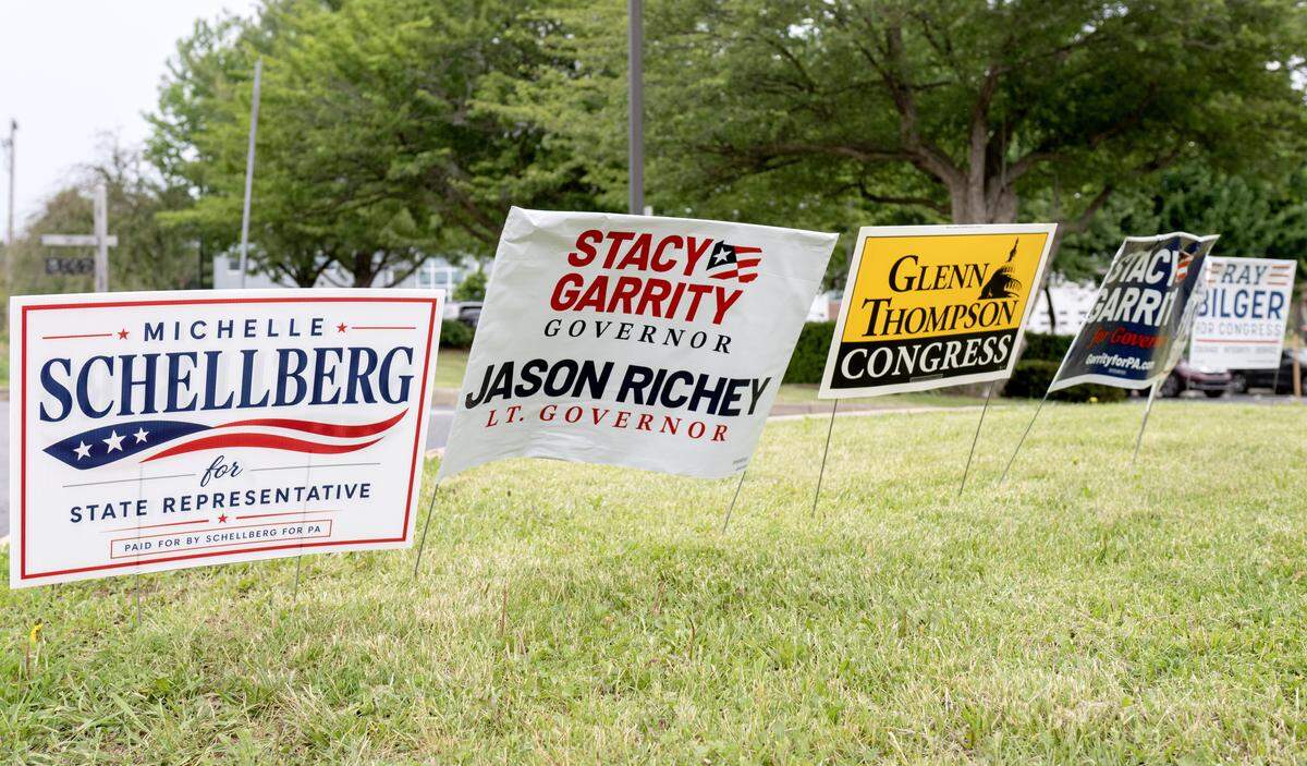 Signs promoting candidates including Michelle Schellberg, Stacy Garrity and Glenn Thompson outside the Ferguson Township Building on primary election day on Tuesday, May 19, 2026.