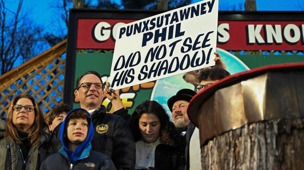 Pennsylvania Gov. Josh Shapiro watches Punxsutawney Phil, the weather prognosticating groundhog, on Friday during the 138th celebration of Groundhog Day on Gobbler’s Knob in Punxsutawney. Phil’s handlers said that the groundhog has forecast an early spring. 