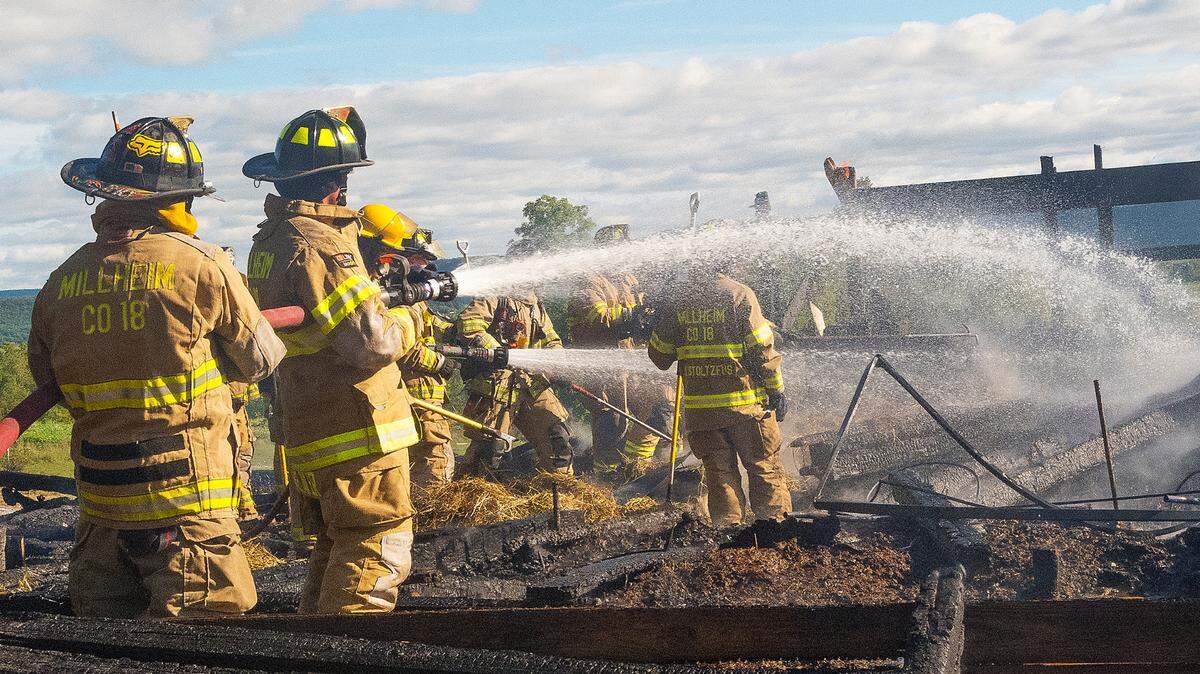 Hose crews spraying the area to knock down any hot spots at a barn fire on Paso Lane in Penn Township on Thursday, Sept. 29, 2022.